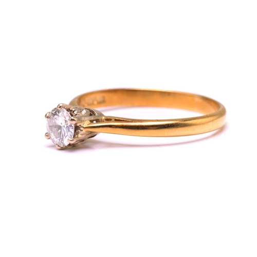 15 - A diamond solitaire ring in 18ct bi-coloured gold, featuring a round brilliant diamond with an estim... 