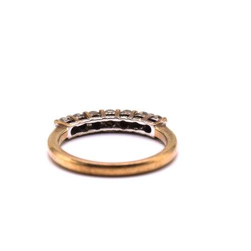 187 - A 9ct gold seven-stone diamond ring, consisting of seven brilliant diamonds with an estimated total ... 