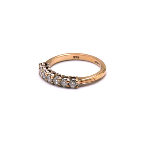187 - A 9ct gold seven-stone diamond ring, consisting of seven brilliant diamonds with an estimated total ... 
