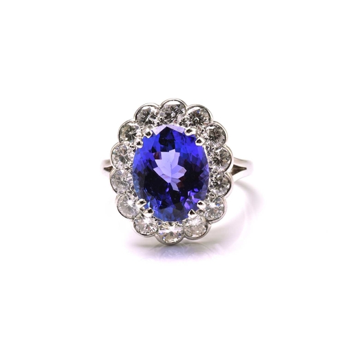 211 - A platinum tanzanite entourage ring, featuring an oval mixed-cut tanzanite with intense purplish-blu... 