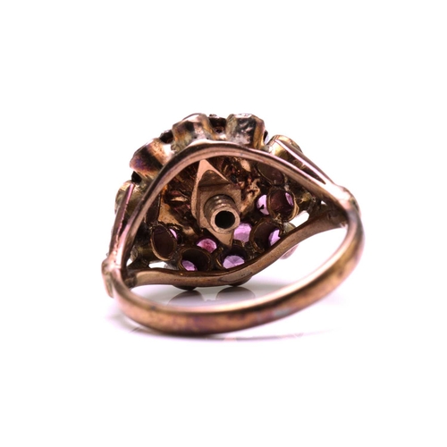 229 - A bombé ring encrusted with pink sapphires, with a screw-top claw mount with a pink sapphire highlig... 