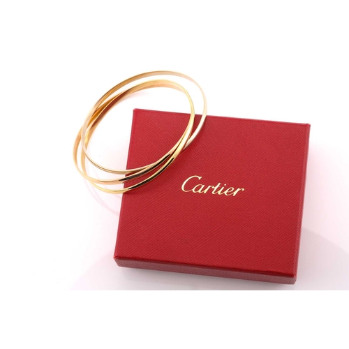 33 - A Cartier trinity bracelet, featuring three interlocking bands in 18ct yellow, pink and white gold, ... 