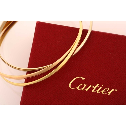 33 - A Cartier trinity bracelet, featuring three interlocking bands in 18ct yellow, pink and white gold, ... 
