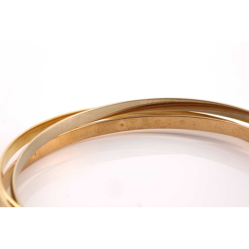 33 - A Cartier trinity bracelet, featuring three interlocking bands in 18ct yellow, pink and white gold, ... 