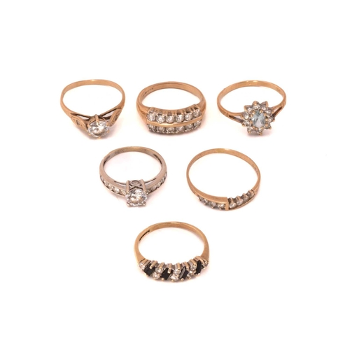 64 - A selection of gem-set rings; to include a CZ half hoop ring in 14ct gold, London 1994, size T; a tw... 