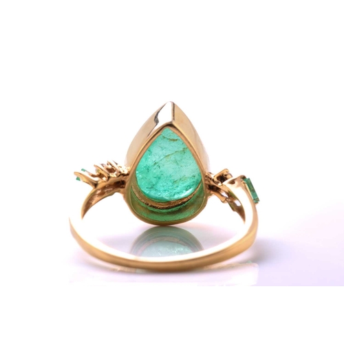 79 - An emerald and diamond 18ct gold ring, centred with a pear-shaped emerald double cabochon, approxima... 