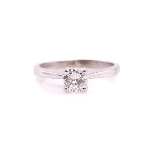 80 - A single stone diamond ring, the round brilliant cut diamond in simple raised claw mount; to taperin... 