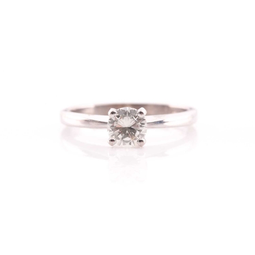 80 - A single stone diamond ring, the round brilliant cut diamond in simple raised claw mount; to taperin... 