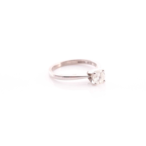 80 - A single stone diamond ring, the round brilliant cut diamond in simple raised claw mount; to taperin... 