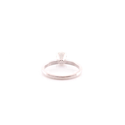 80 - A single stone diamond ring, the round brilliant cut diamond in simple raised claw mount; to taperin... 