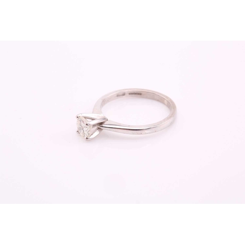 80 - A single stone diamond ring, the round brilliant cut diamond in simple raised claw mount; to taperin... 
