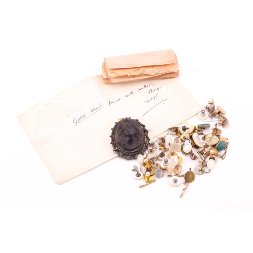 85 - A moulded glass cameo style brooch; the purple frosted glass bust portrait of a woman with ringlets ... 