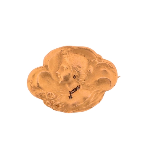 87 - A French Art Nouveau habillé portrait brooch, repoussé depicting a side profile of a lady, with gems... 