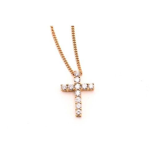 89 - An 18ct gold and diamond-set cross pendant on chain, consisting of eleven brilliant diamonds with an... 