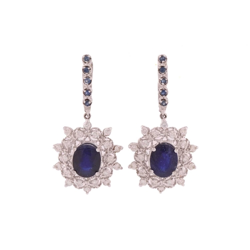 92 - A pair of sapphire and diamond drop earrings, each comprising an oval faceted sapphire with dark blu... 
