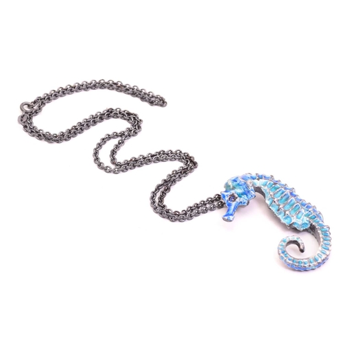 252 - A casted figural seahorse pendant on chain, with teal and blue coloured cold enamel finishing, eye s... 