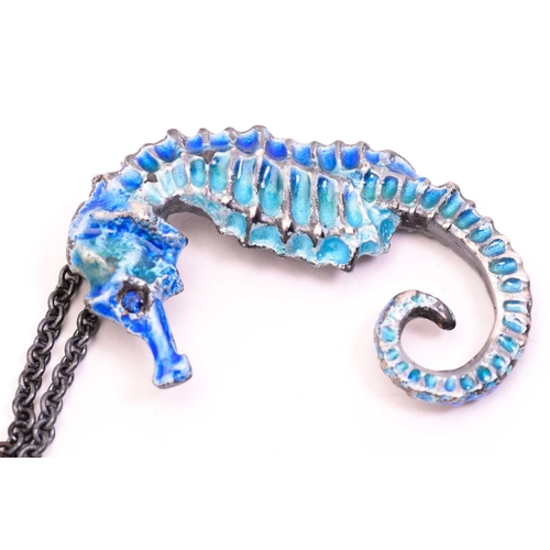 252 - A casted figural seahorse pendant on chain, with teal and blue coloured cold enamel finishing, eye s... 