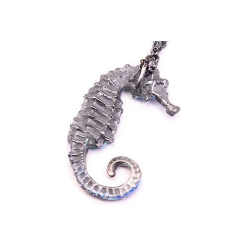 252 - A casted figural seahorse pendant on chain, with teal and blue coloured cold enamel finishing, eye s... 