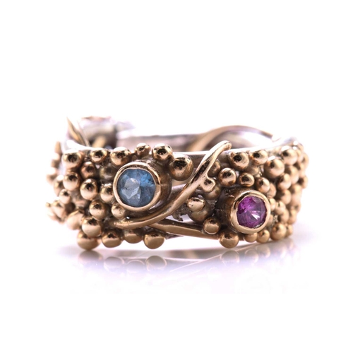 261 - A 9ct bi-coloured gold cocktail ring with pink sapphire and aquamarine highlights, on a twisted wire... 