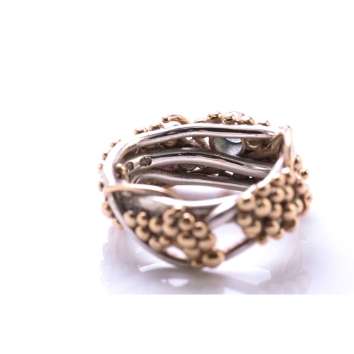 261 - A 9ct bi-coloured gold cocktail ring with pink sapphire and aquamarine highlights, on a twisted wire... 