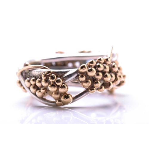 261 - A 9ct bi-coloured gold cocktail ring with pink sapphire and aquamarine highlights, on a twisted wire... 