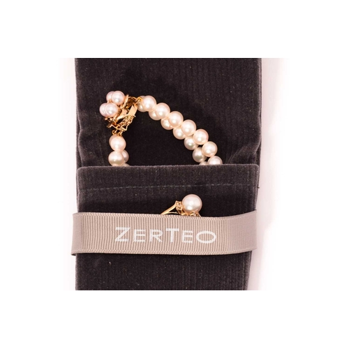 262 - A double row pearl bracelet with a matching ring, the bracelet comprises two strands of 6.0 mm round... 