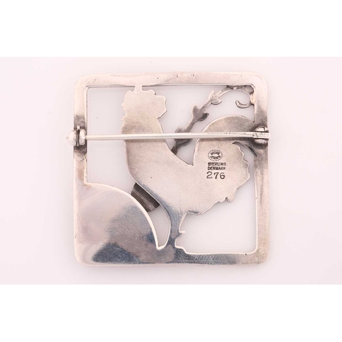 264 - Georg Jensen - A cockerel brooch, depicting a cockerel with fern accent in a square frame, with hing... 