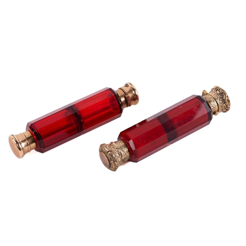 288 - Two Victorian ruby glass double-ended scent bottles; the first has gilt floral terminations, engrave... 