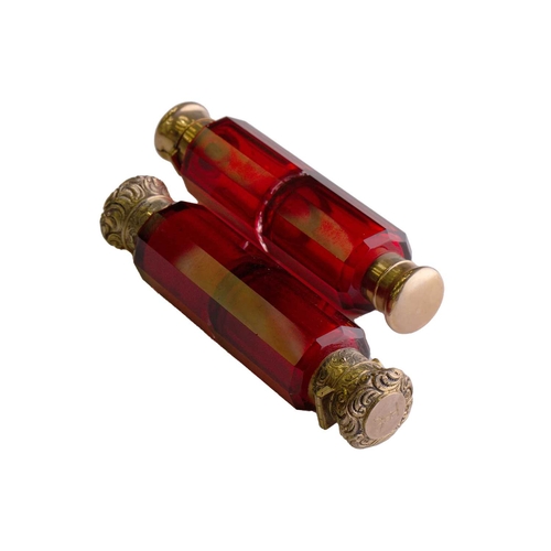 288 - Two Victorian ruby glass double-ended scent bottles; the first has gilt floral terminations, engrave... 