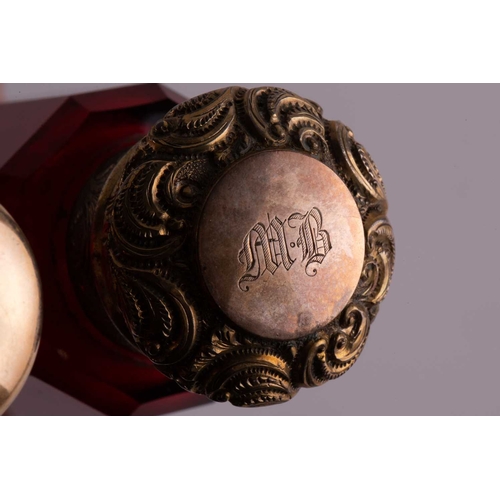 288 - Two Victorian ruby glass double-ended scent bottles; the first has gilt floral terminations, engrave... 