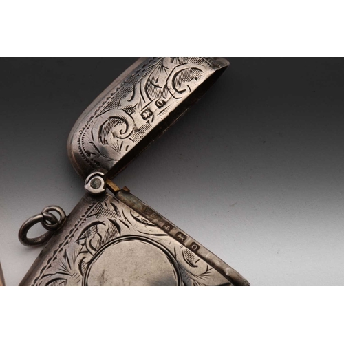 421 - A Victorian silver vesta case; rounded rectangular, foliate engraved, with side hinged opening and s... 