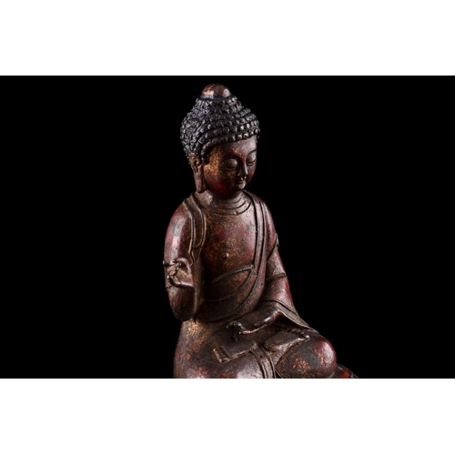 101 - A Chinese bronze figure of Buddha, seated in Abhaya mudra, the hair in tight curls, seated on a lotu... 