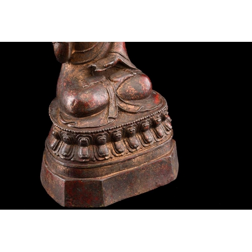 101 - A Chinese bronze figure of Buddha, seated in Abhaya mudra, the hair in tight curls, seated on a lotu... 