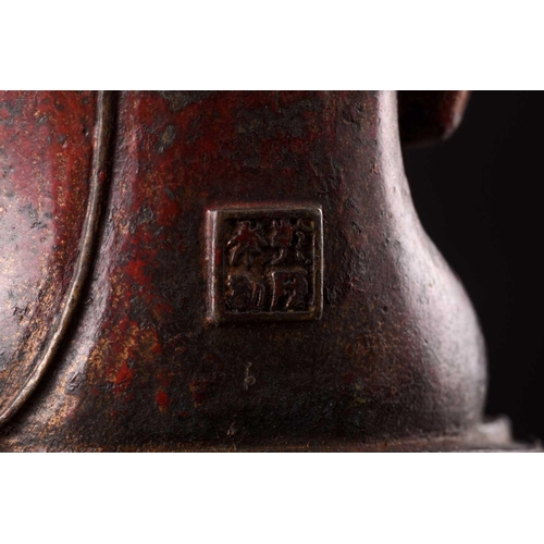 101 - A Chinese bronze figure of Buddha, seated in Abhaya mudra, the hair in tight curls, seated on a lotu... 