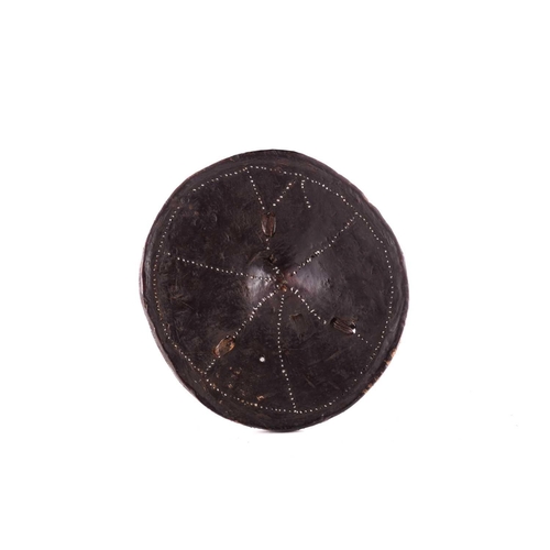 107 - Ethnographica comprising a hide parrying shield inlaid with white metal, 24.5cm dia, a Nigerian feti... 