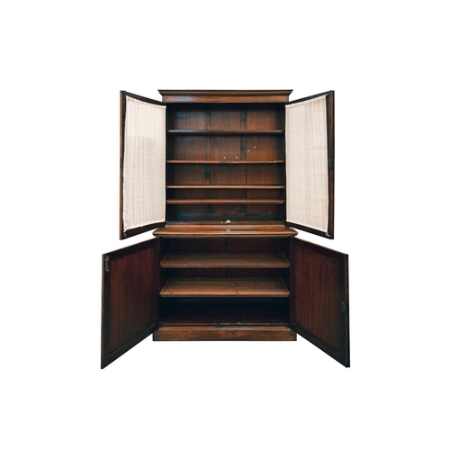 125 - An Edwardian mahogany cupboard bookcase with a pair of plain glazed upper doors over a base with a p... 