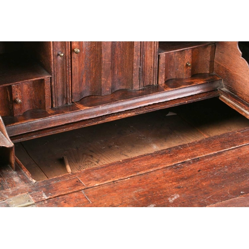 127 - A George I/II oak fall front writing bureau, the interior with concealed drawers and a well. Fitted ... 