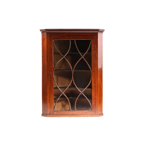 133 - A George III oak single door hanging corner cupboard with elliptical glazing. 84 cm wide x 112 cm ov... 