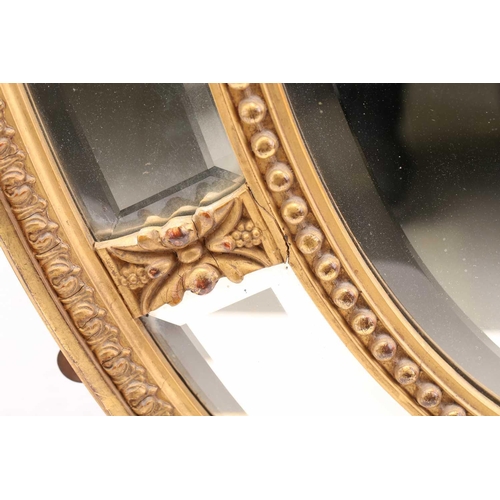 134 - A George III style carved wood and gilt gesso oval wall mirror, late 19th/20th century. with bevelle... 