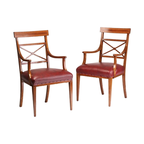 137 - A set of twelve Edwardian mahogany Sheraton revival dining chairs including ten singles and two carv... 