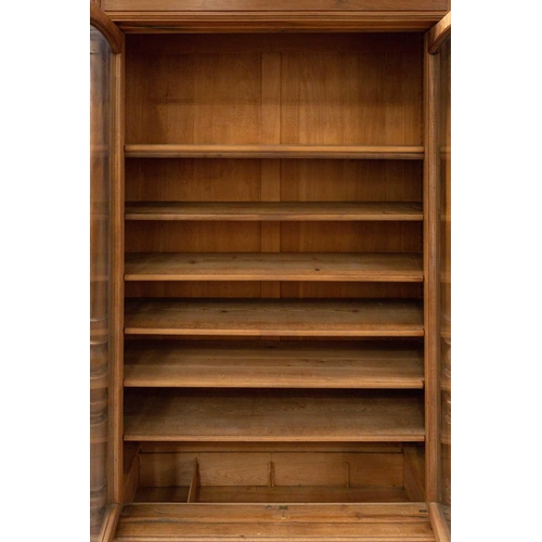 144 - An early 20th century French/Swiss walnut two-door bookcase with a pair of plain glazed doors enclos... 