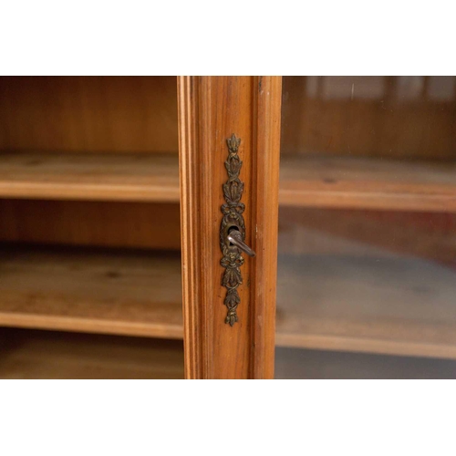 144 - An early 20th century French/Swiss walnut two-door bookcase with a pair of plain glazed doors enclos... 