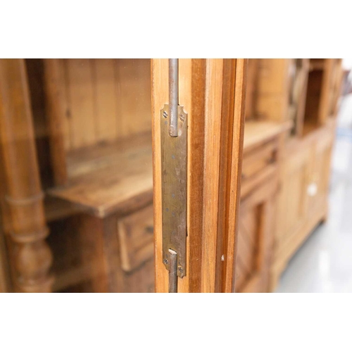 144 - An early 20th century French/Swiss walnut two-door bookcase with a pair of plain glazed doors enclos... 