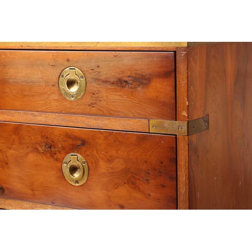 150 - A small good quality yew wood campaign-style chest of drawers with brass banding and recessed ring-p... 