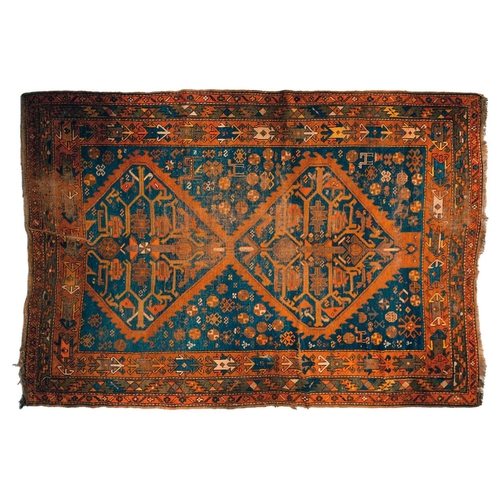 168 - An early 20th century Caucasian Kazak rug, with four square medallions on an indigo blue ground with... 