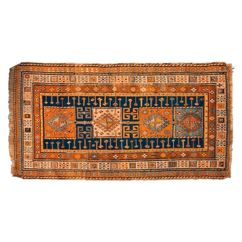 168 - An early 20th century Caucasian Kazak rug, with four square medallions on an indigo blue ground with... 