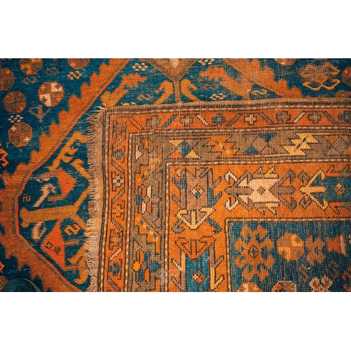 168 - An early 20th century Caucasian Kazak rug, with four square medallions on an indigo blue ground with... 