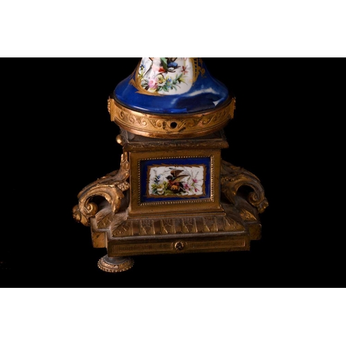 171 - A small french Napoleon III patinated bronze and ormolu mantle clock with a surmount in the form of ... 