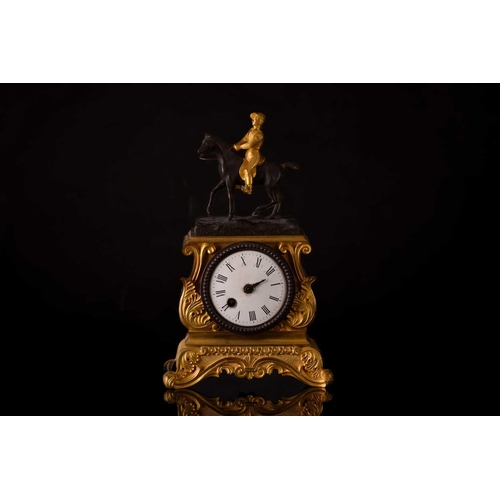 171 - A small french Napoleon III patinated bronze and ormolu mantle clock with a surmount in the form of ... 