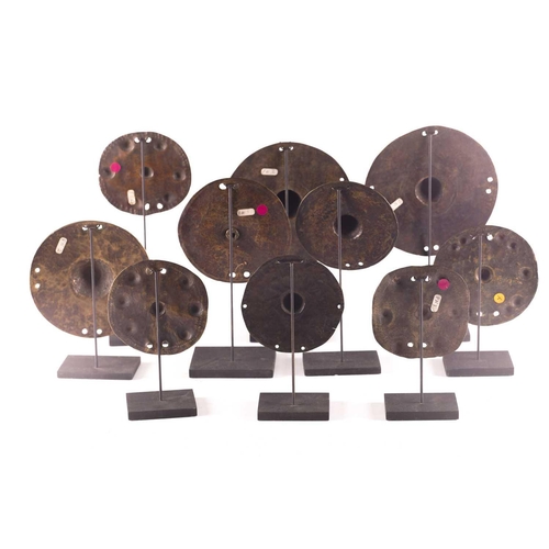 184 - A collection of twelve bronze shield bosses, with embossed or stamped decoration, 10.5cm - 16.5cm di... 